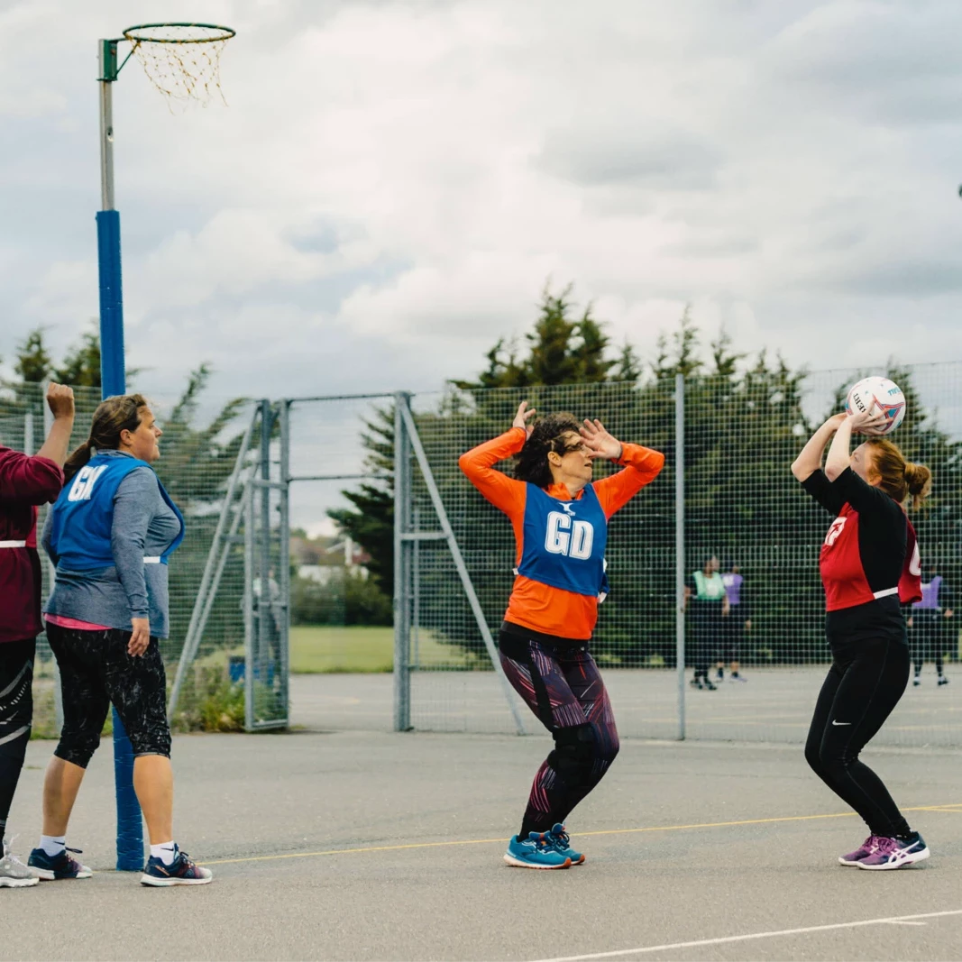 Netball player shooting for goal